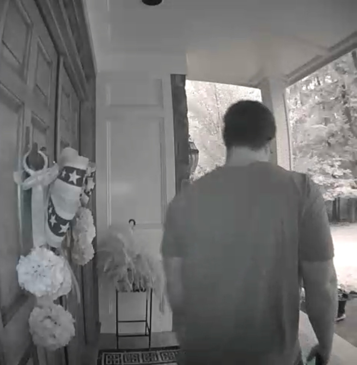 Doorbell-camera image reportedly showing a casually dressed visitor at a private residence during an unannounced weekend visit.